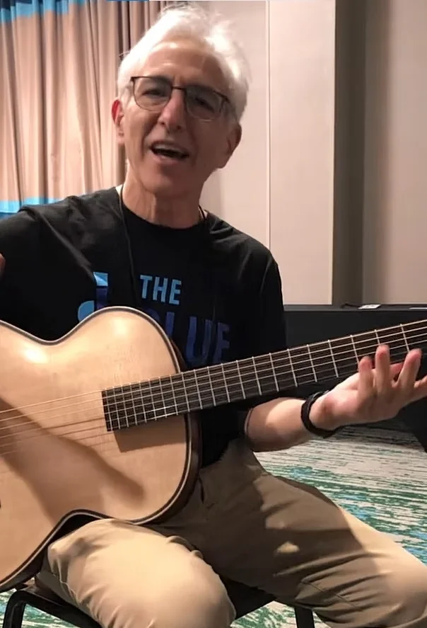 Doug Baumoel playing guitar