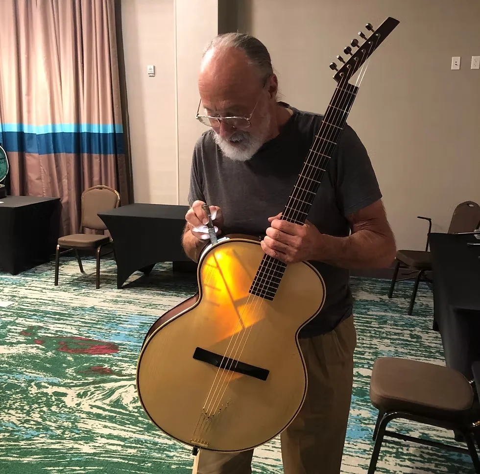 Ken Parker inspecting guitar interior