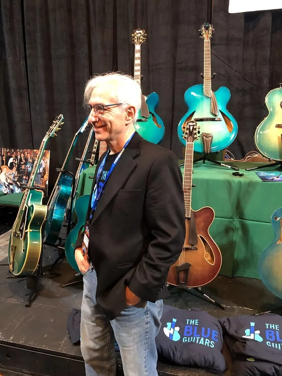 Acoustic archtop guitars lined up at Foundation booth