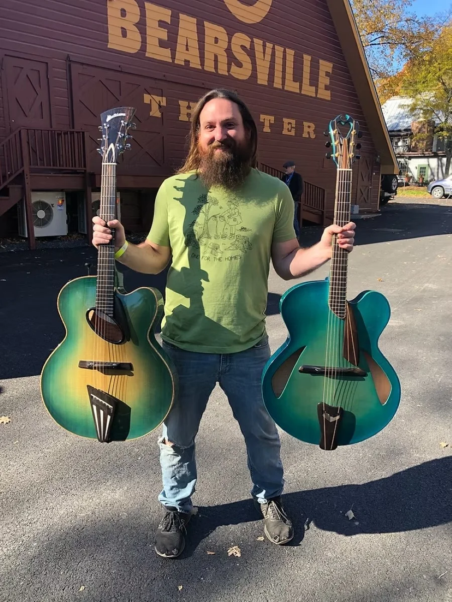 Luthiers and visitors discussing archtop guitars